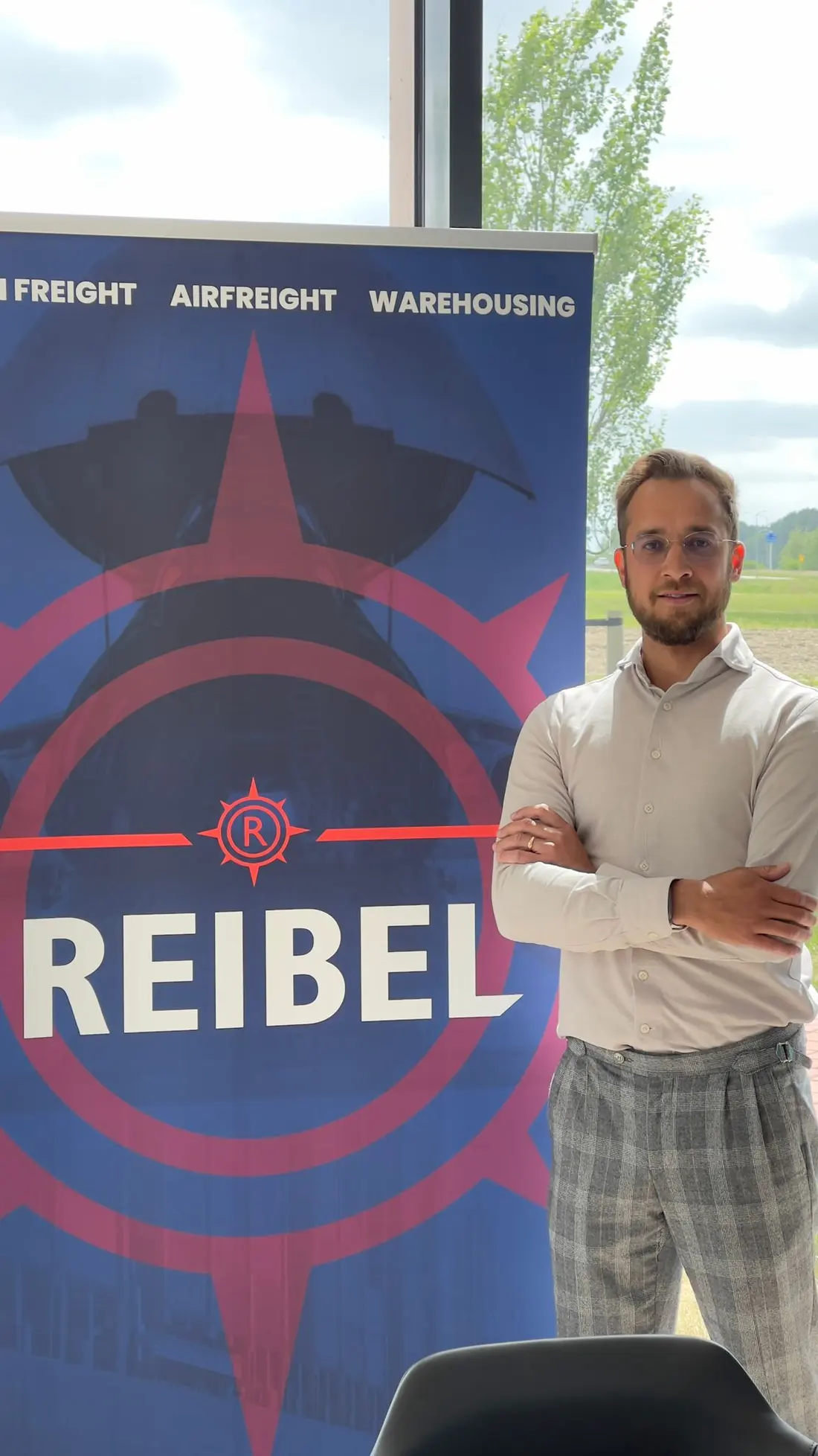 A member of the Reibel team next to a Reibel banner